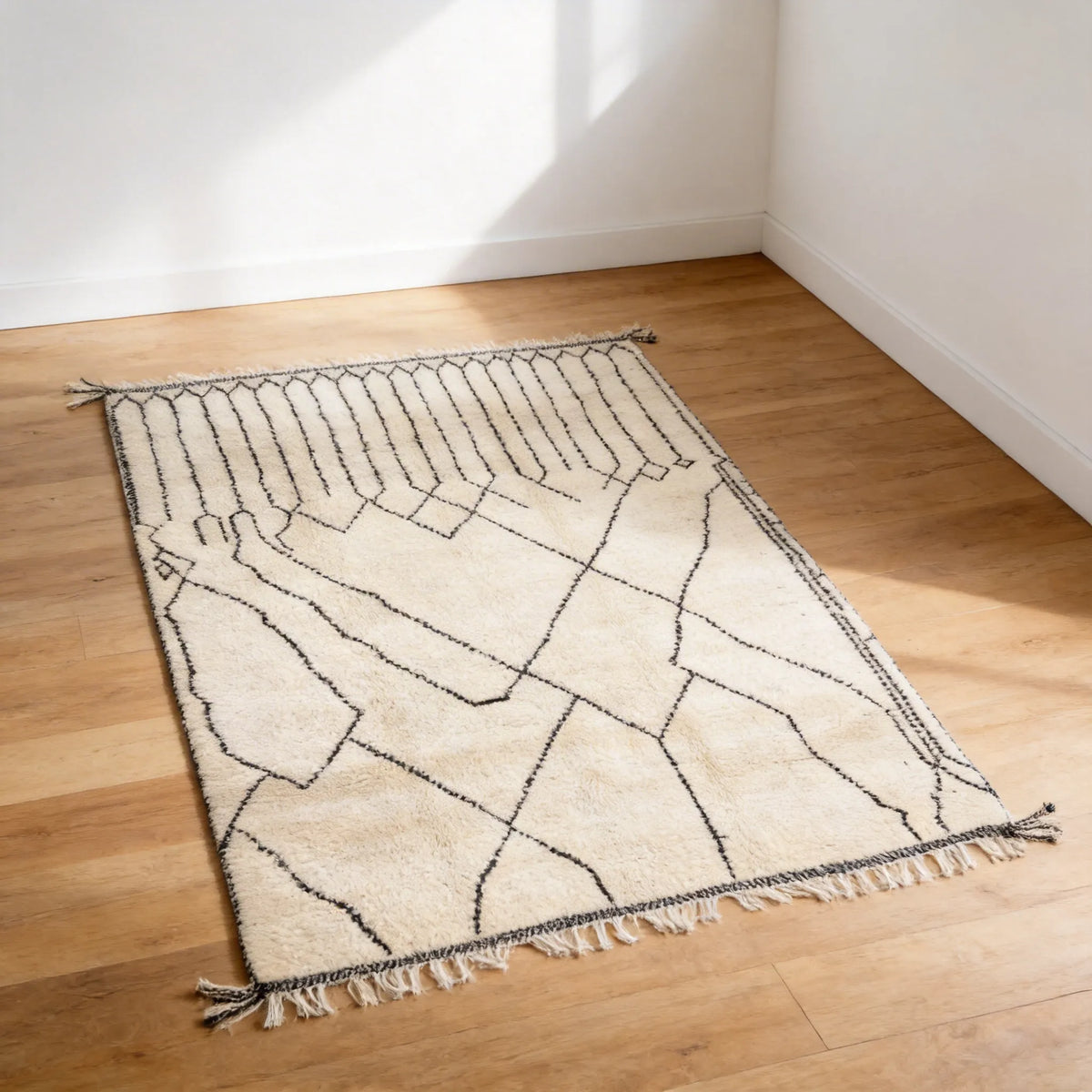 Mrirt wool rug, black grid leading into irregular diamonds on a cream ground in a hallway setting