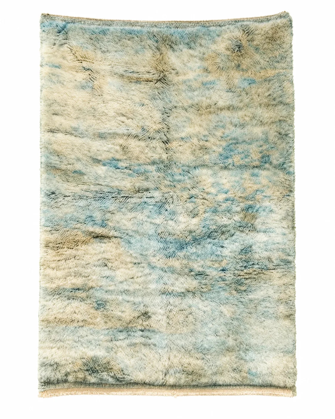 Mrirt wool rug, light ocean blue and warm sand tones flowing across a cream ground in a living room setting